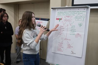 Uczniowie opowiadający co napisali na flip charcie